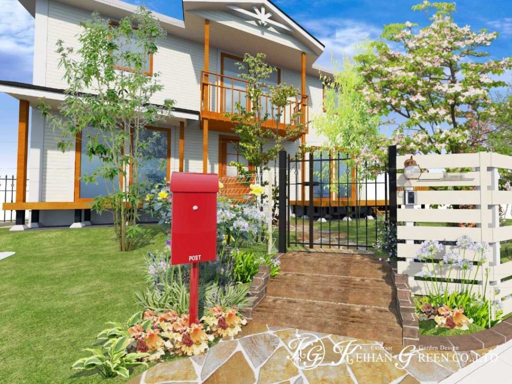 白いフェンスと赤いポストが大人かわいいエントランス